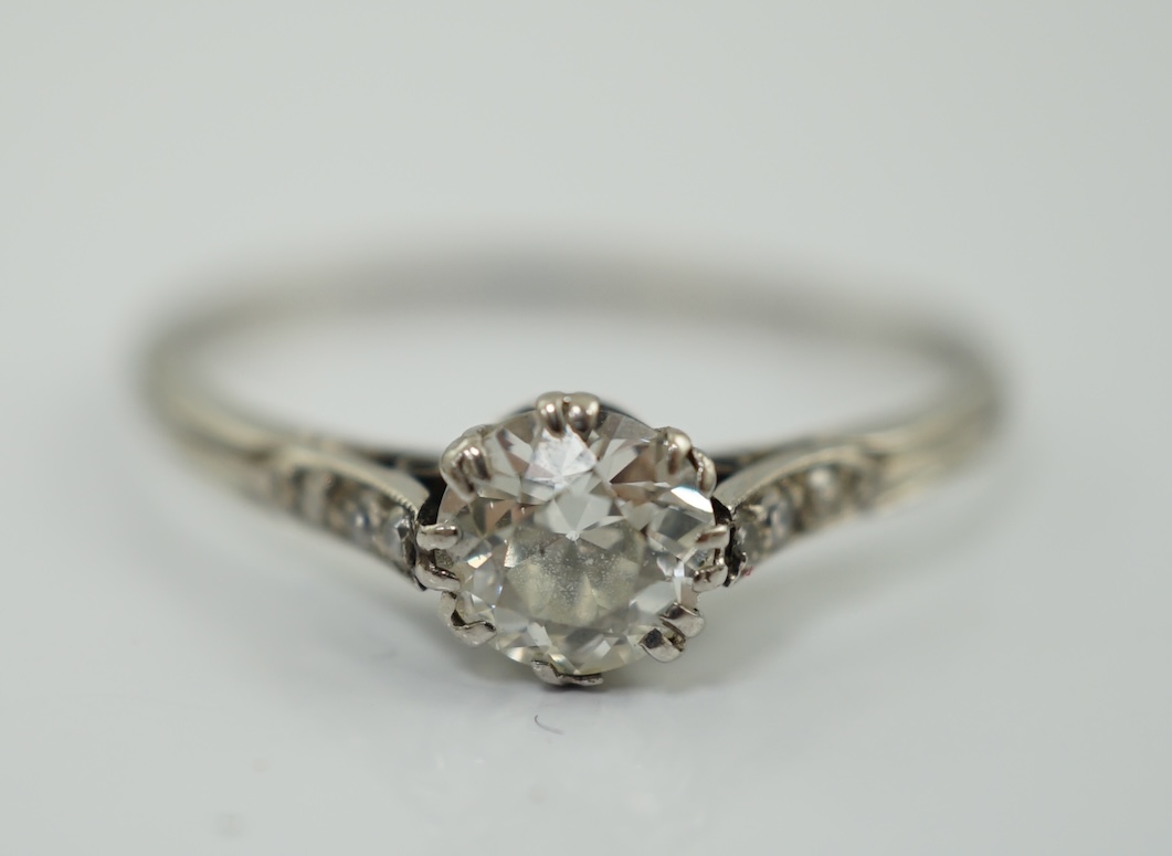 A platinum? and single stone diamond set ring, with six stone diamond chip set shoulders